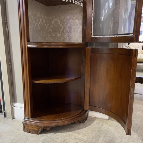 469 - A floor standing corner cupboard with glazed single door and door below