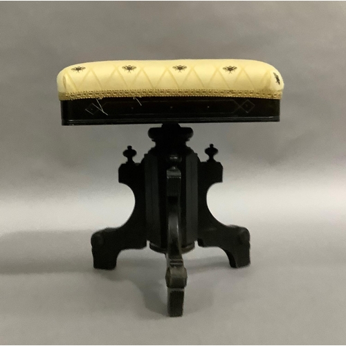 470 - A Victorian ebonised piano stool with rectangular swivel top, upholstered in bee fabric