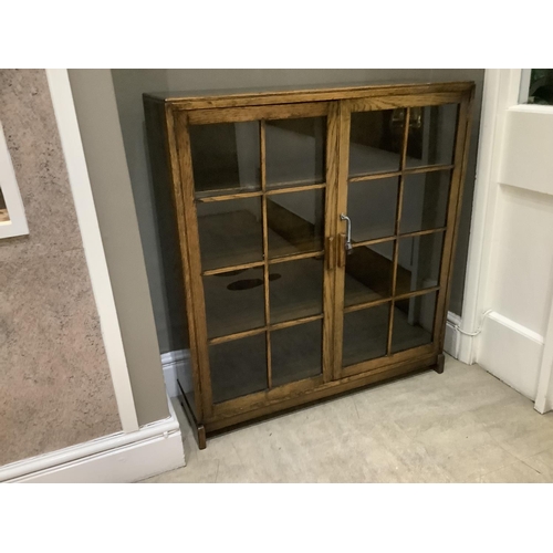 472 - An oak and glazed two door bookcase with interior shelves, circa 1930s/1940s