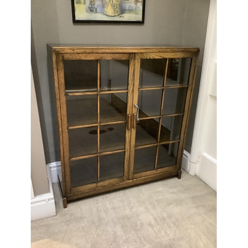 472 - An oak and glazed two door bookcase with interior shelves, circa 1930s/1940s