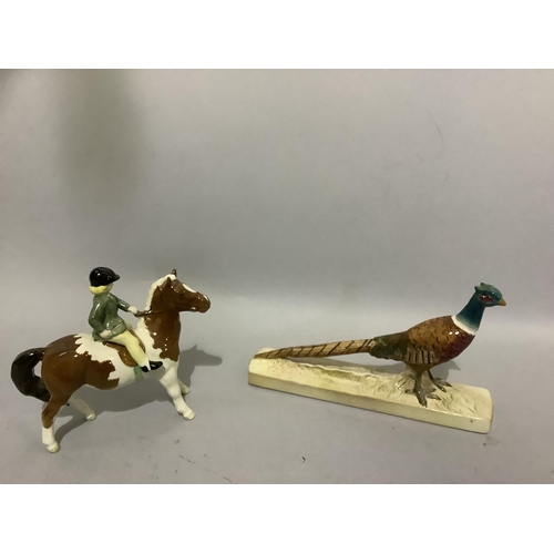 6D - A Beswick brown and white pony with rider and a pheasant on rectangular plinth