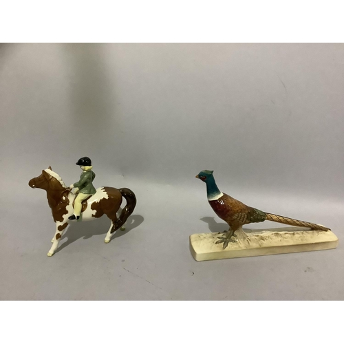 6D - A Beswick brown and white pony with rider and a pheasant on rectangular plinth