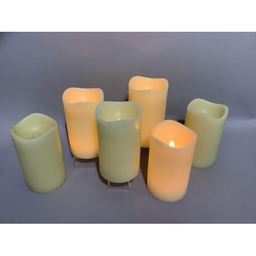 349 - A box containing six large LED faux candles