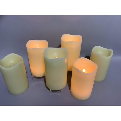 349 - A box containing six large LED faux candles