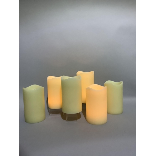 349 - A box containing six large LED faux candles