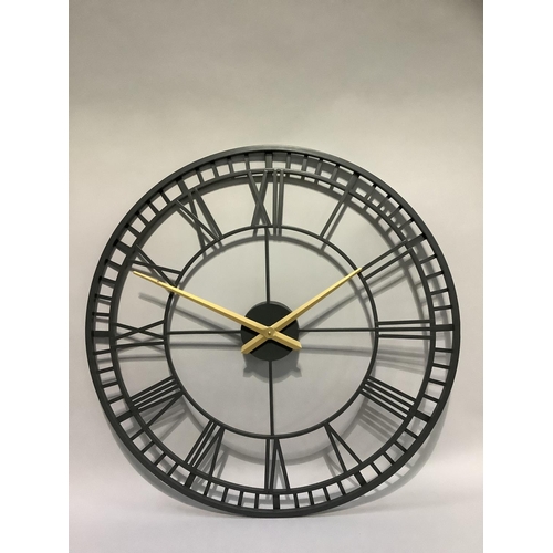 381 - A black and gilt skeletal wall clock with Roman numerals, 82cm diameter