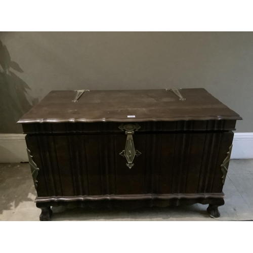 474 - A dark stained and brass mounted ottoman with strap handles and lock, on short cabriole legs, claw a... 