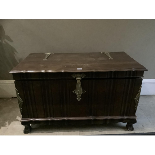 474 - A dark stained and brass mounted ottoman with strap handles and lock, on short cabriole legs, claw a... 