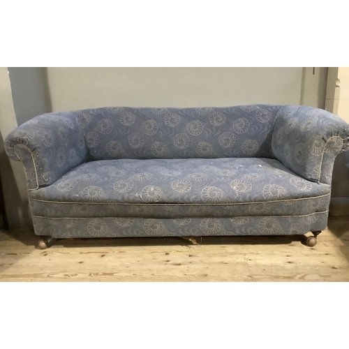 475 - An early 20th century Chesterfield sofa having a rolled back and arms, upholstered in the original p... 