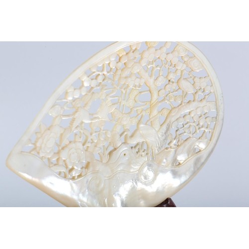 293 - A Chinese mother-of-pearl shell, carved and pierced with egrets, pine tree and peony, 17cm x 13.5cm ... 