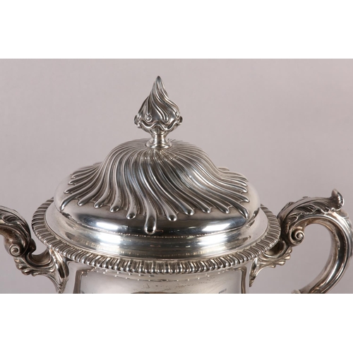 196 - A VICTORIAN SILVER TROPHY CUP with domed lid and two foliate c-scroll handles, wrythen chased to the... 