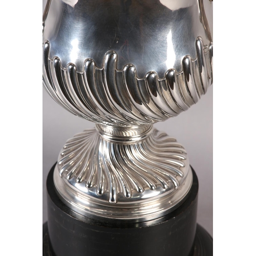 196 - A VICTORIAN SILVER TROPHY CUP with domed lid and two foliate c-scroll handles, wrythen chased to the... 