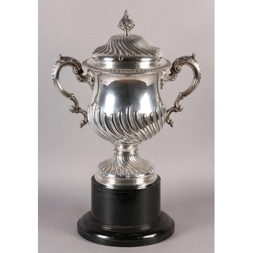 196 - A VICTORIAN SILVER TROPHY CUP with domed lid and two foliate c-scroll handles, wrythen chased to the... 