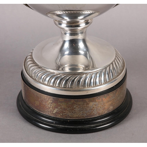 197 - A GEORGE V SILVER TROPHY CUP and domed cover with acorn finial, twin loop handles, gadroon rims, rai... 