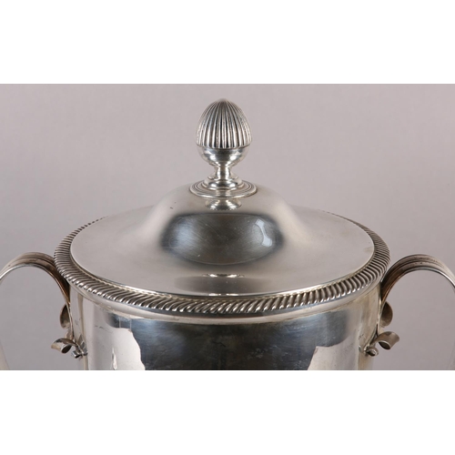 197 - A GEORGE V SILVER TROPHY CUP and domed cover with acorn finial, twin loop handles, gadroon rims, rai... 