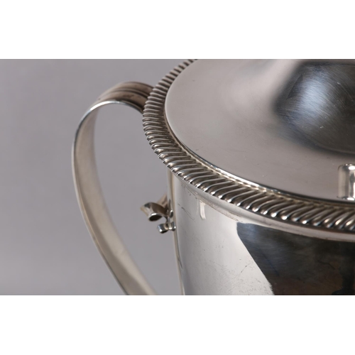 197 - A GEORGE V SILVER TROPHY CUP and domed cover with acorn finial, twin loop handles, gadroon rims, rai... 