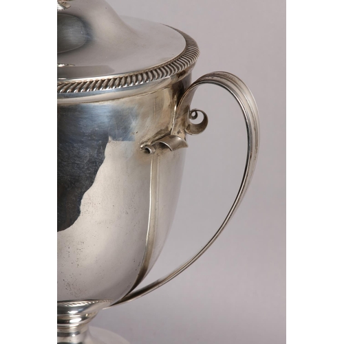 197 - A GEORGE V SILVER TROPHY CUP and domed cover with acorn finial, twin loop handles, gadroon rims, rai... 