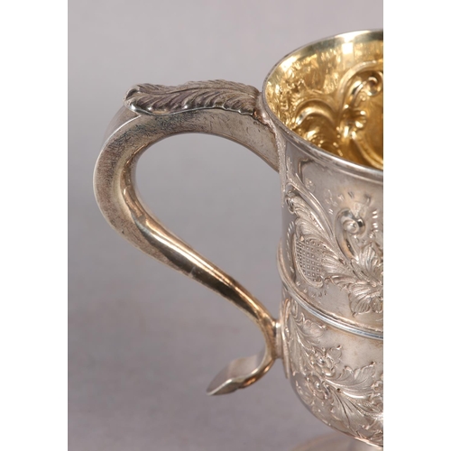 194 - A GEORGE III SILVER TROPHY CUP with rose chasing, banded with foliate c-scroll handles, later engrav... 