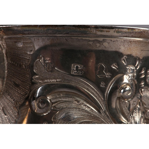 194 - A GEORGE III SILVER TROPHY CUP with rose chasing, banded with foliate c-scroll handles, later engrav... 