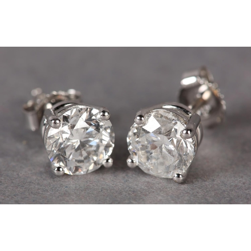 302 - A PAIR OF DIAMOND STUD EARRINGS, the brilliant cut stones claw set in white metal (tests as 18ct gol... 