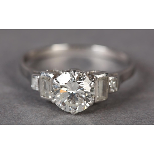 303 - A DIAMOND RING in platinum c.1950, the brilliant cut principal stone claw set and flanked by four gr... 