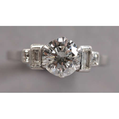 303 - A DIAMOND RING in platinum c.1950, the brilliant cut principal stone claw set and flanked by four gr... 