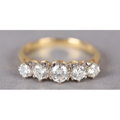 307 - A FIVE STONE DIAMOND RING in 18ct yellow and white gold, the graduated brilliant cut stones claw set... 