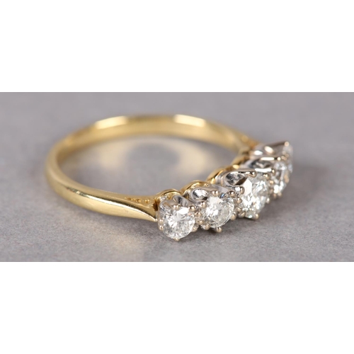 307 - A FIVE STONE DIAMOND RING in 18ct yellow and white gold, the graduated brilliant cut stones claw set... 