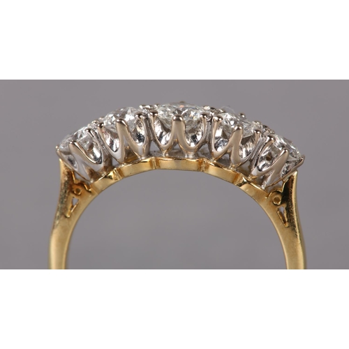 307 - A FIVE STONE DIAMOND RING in 18ct yellow and white gold, the graduated brilliant cut stones claw set... 