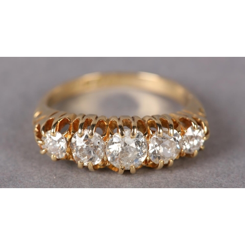 297 - A VICTORIAN FIVE STONE DIAMOND RING in 18ct gold, the Old European cut stones claw set in line in a ... 