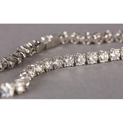 287 - A DIAMOND TENNIS BRACELET, the brilliant cut stones claw set in line in white metal (tests as platin... 