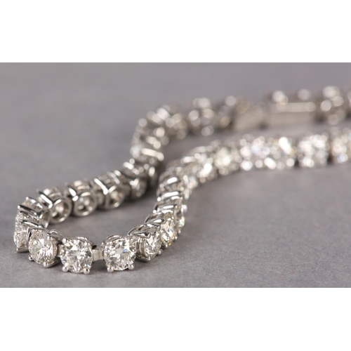 287 - A DIAMOND TENNIS BRACELET, the brilliant cut stones claw set in line in white metal (tests as platin... 