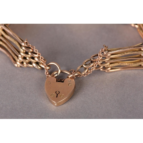 309 - A VICTORIAN GATE BRACELET in 9ct rose gold, the links textured and polished, padlock fastener, appro... 