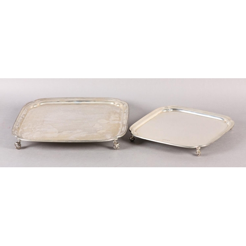 235 - A PAIR OF GEORGE V SILVER TRAYS, of square outline and graduated size with indented corners on four ... 