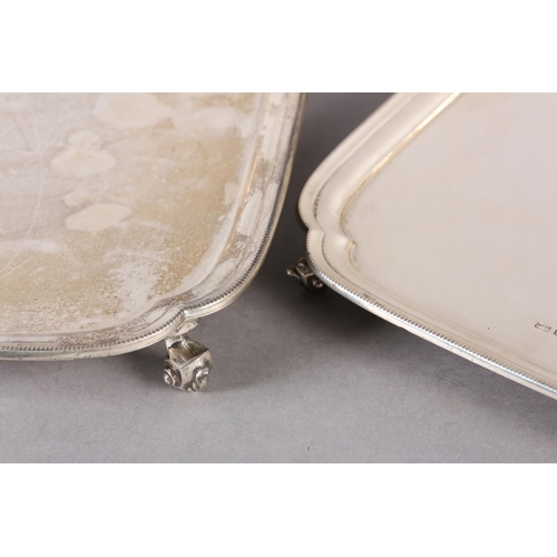 235 - A PAIR OF GEORGE V SILVER TRAYS, of square outline and graduated size with indented corners on four ... 