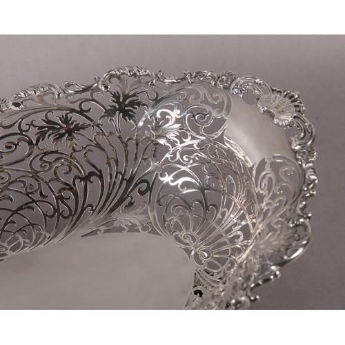 206 - AN EDWARD VII SILVER BASKET  retailed by  Ryrie Brothers of Toronto of oval outline with shell and C... 