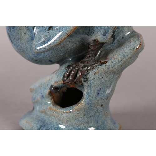 167 - A CHINESE STONEWARE FIGURE OF A HAWK perched on a rock, blue-grey glaze, impressed signature to unde... 