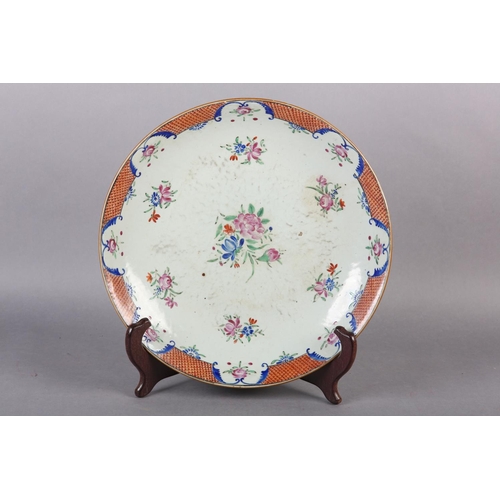 169 - A CHINESE FAMILLE ROSE CHARGER, painted with peony and other flowers within an iron red diaper cell ... 