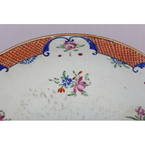 169 - A CHINESE FAMILLE ROSE CHARGER, painted with peony and other flowers within an iron red diaper cell ... 