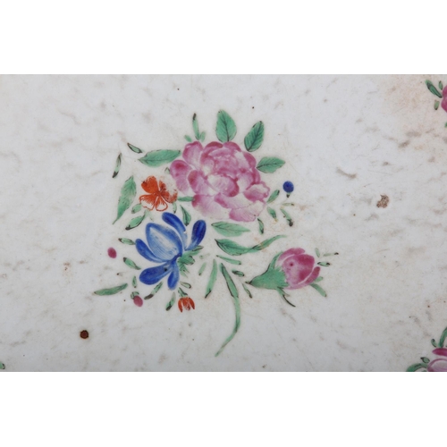 169 - A CHINESE FAMILLE ROSE CHARGER, painted with peony and other flowers within an iron red diaper cell ... 