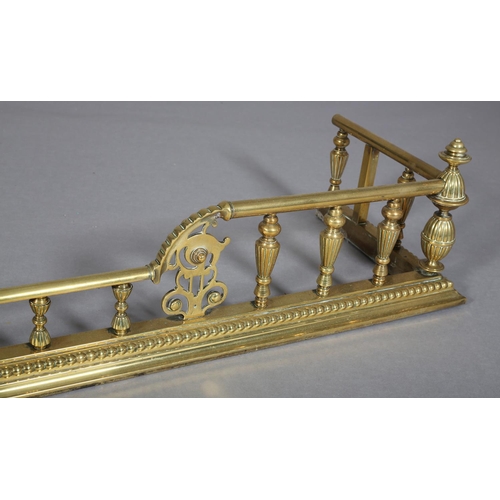 79 - A VICTORIAN BRASS FENDER, having fluted uprights and rounded finials, 149cm wide x 37cm deep (extern... 