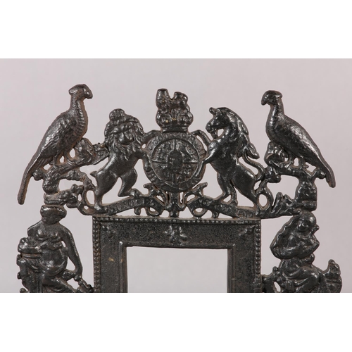 78 - A 19TH CENTURY CAST IRON HEARTH ORNAMENT in the form of a fireplace with coat of arms cresting, flan... 