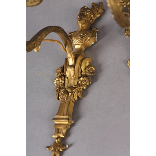 71 - A PAIR OF GILT METAL WALL SCONES CAST with the bust of an emperor and empress above a floral swagged... 