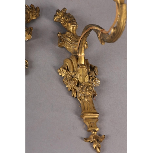 71 - A PAIR OF GILT METAL WALL SCONES CAST with the bust of an emperor and empress above a floral swagged... 