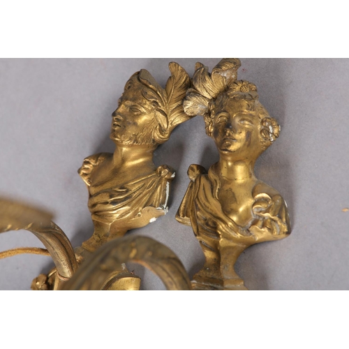 71 - A PAIR OF GILT METAL WALL SCONES CAST with the bust of an emperor and empress above a floral swagged... 