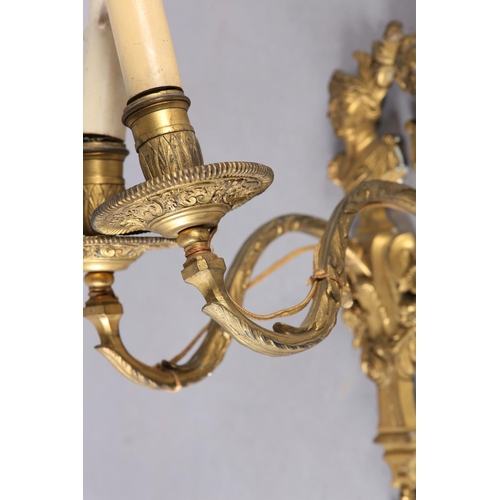 71 - A PAIR OF GILT METAL WALL SCONES CAST with the bust of an emperor and empress above a floral swagged... 