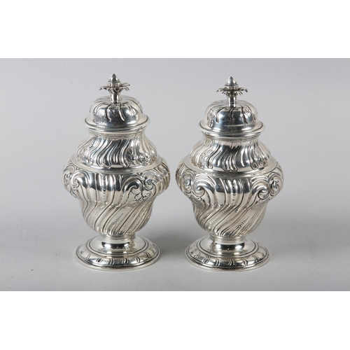 242 - A PAIR OF GEORGE II SILVER CADDIES, Alexander Johnson, London 1757, of writhen baluster vase form wi... 