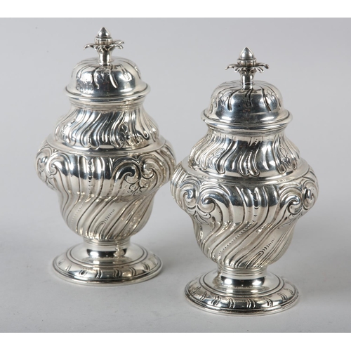 242 - A PAIR OF GEORGE II SILVER CADDIES, Alexander Johnson, London 1757, of writhen baluster vase form wi... 