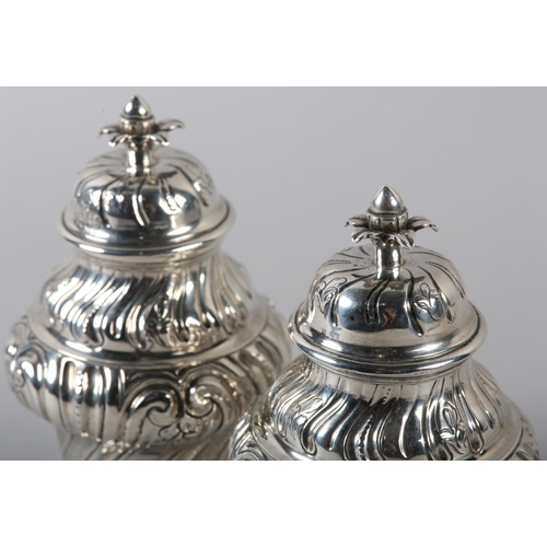 242 - A PAIR OF GEORGE II SILVER CADDIES, Alexander Johnson, London 1757, of writhen baluster vase form wi... 