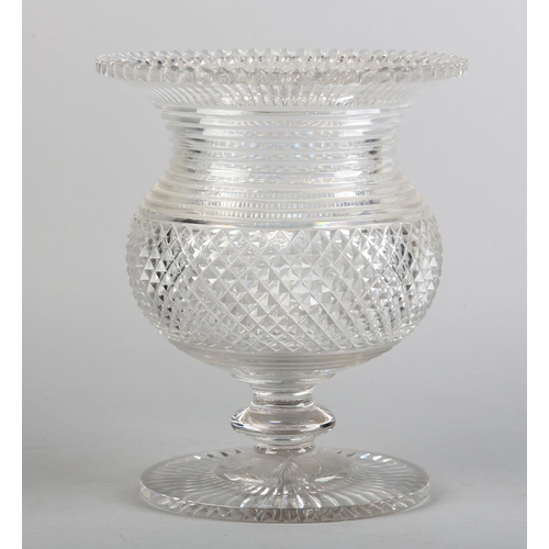 187B - AN IRISH CUT GLASS PEDESTAL URN CENTREPIECE c.1820 with scalloped rim above a step cut neck, the bow... 